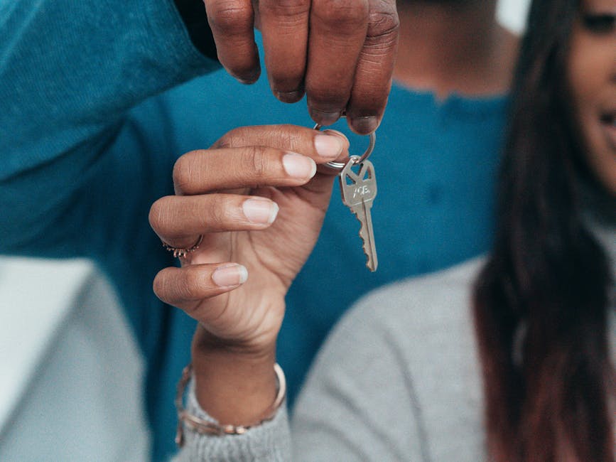 Couple holding key to their new apartment, ready to move in