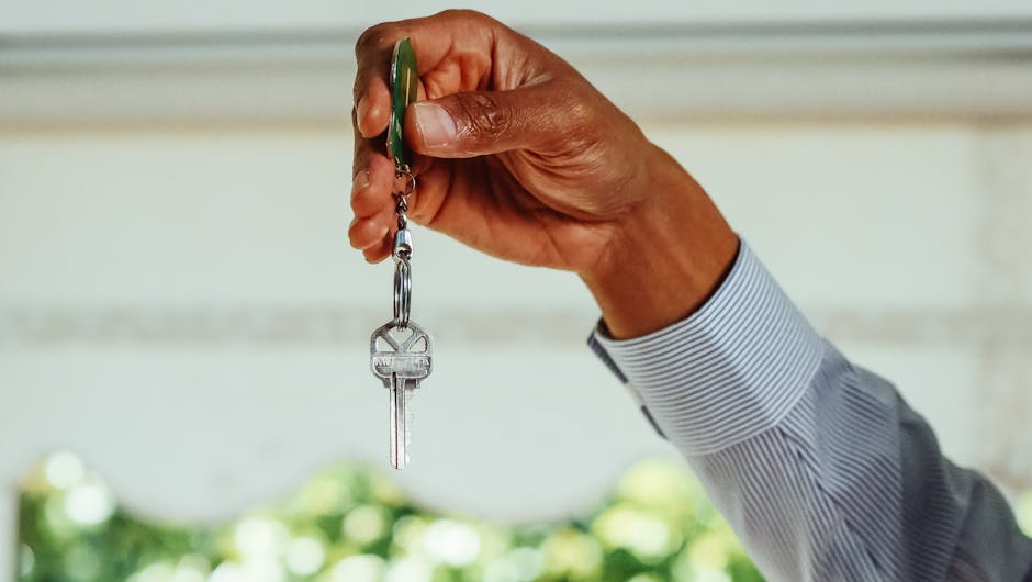 Hand holding apartment keys symbolizing new rental move-in