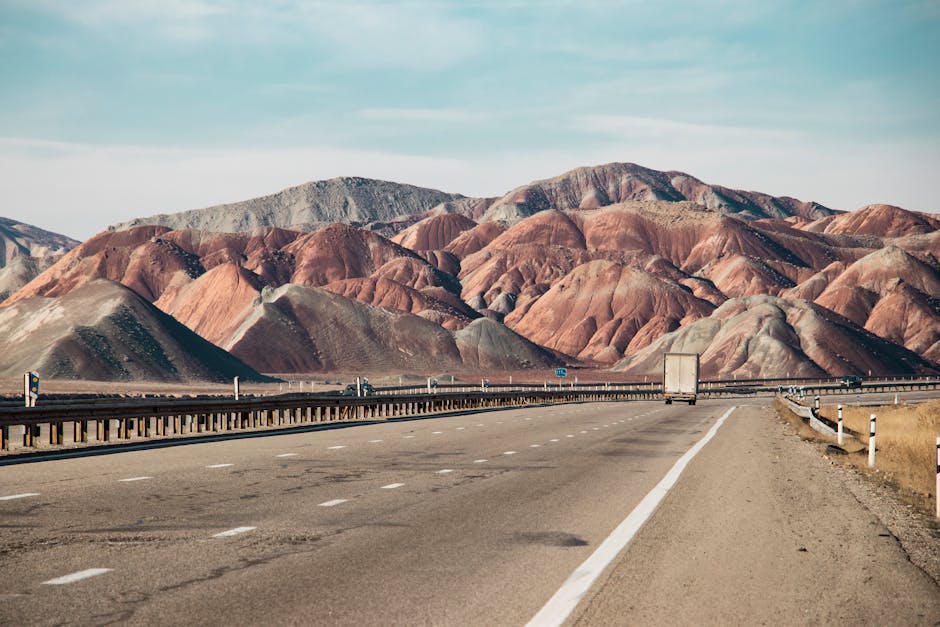 Highway stretching through scenic desert mountain landscape during cross-country move