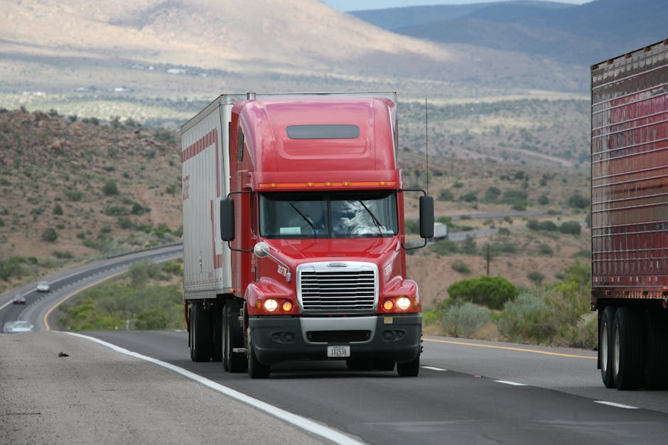 Moving truck driving through scenic mountain highway during interstate relocation