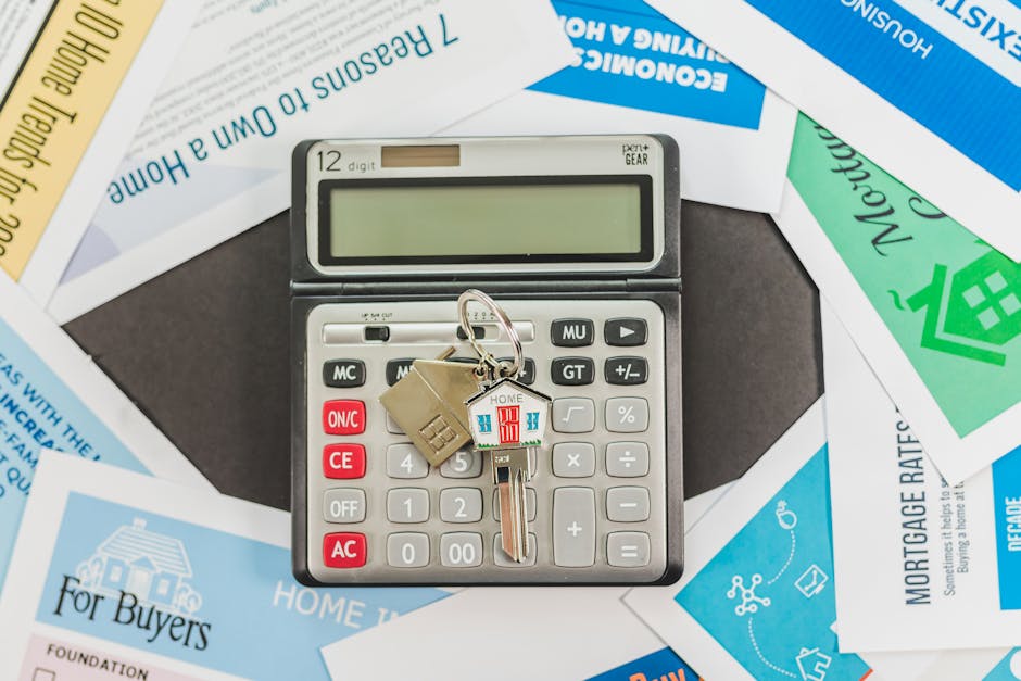 Calculator with keys and real estate documents symbolizing the financial comparison