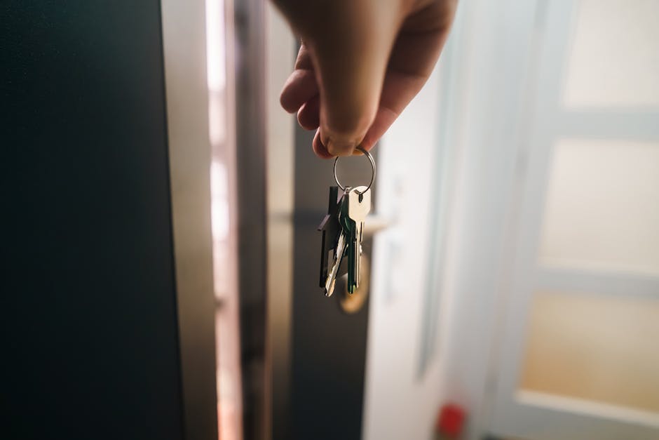 Close-up of hand holding house keys representing successful rent-to-own purchase