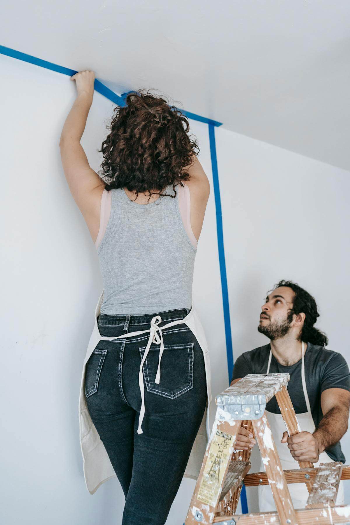 Couple working together on a home renovation project after buying an as-is property