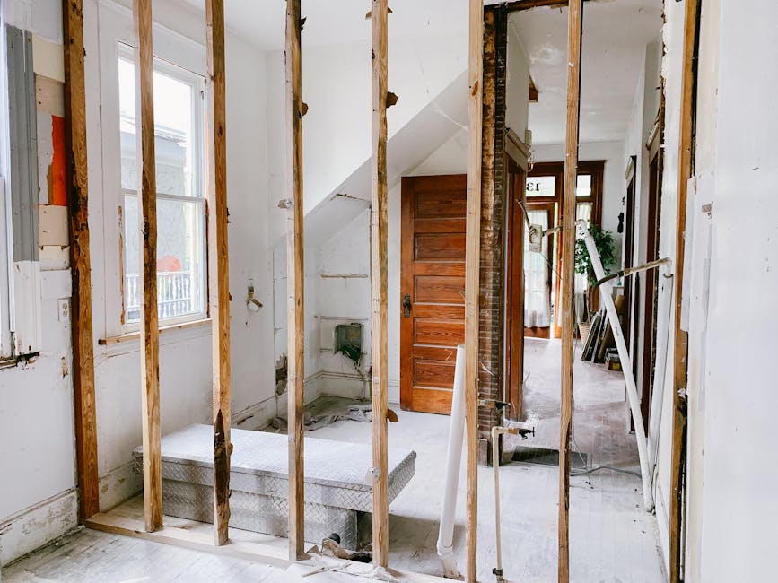 Interior view of a home under renovation with exposed wooden beams