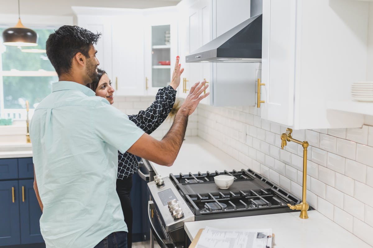 Real estate agent demonstrating kitchen features during an open house tour