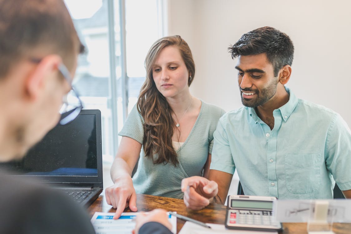 Person signing home purchase documents at closing table