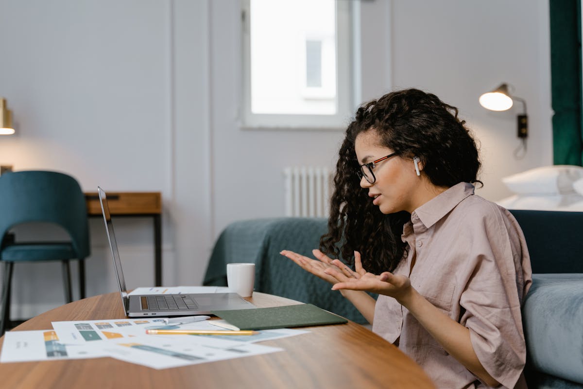 Woman working remotely from her home office while researching where to buy a house