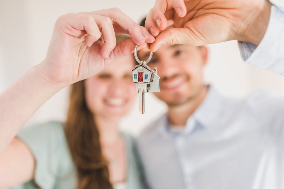 First-time home buyers holding keys to their new home