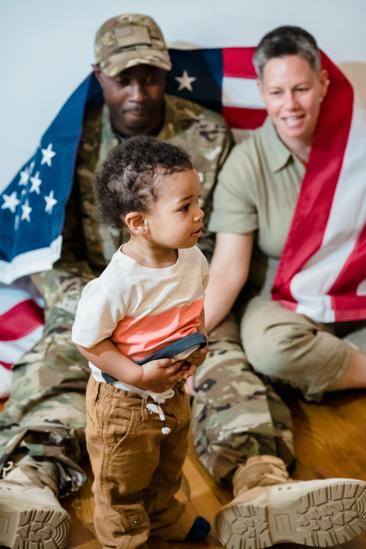 Veteran family with American flag showing pride in military service and homeownership
