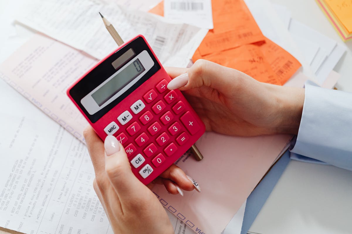 Calculator and financial documents for calculating PMI costs on a mortgage