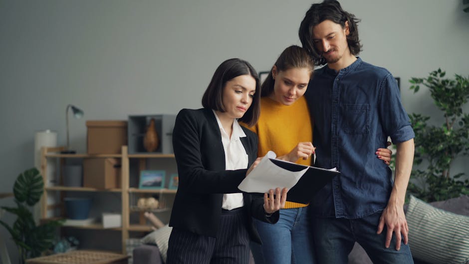 Young couple consulting with a real estate agent about selling their property